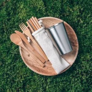 Bamboo utensils and cups on a grass background