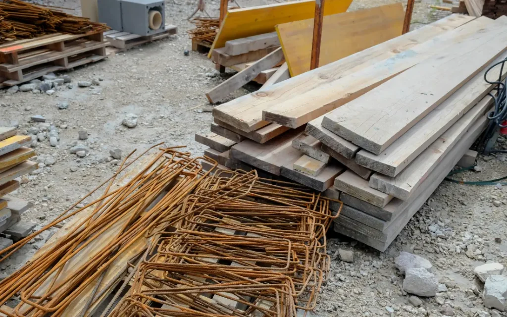 Stacked wood and metal at a construction site: examples of construction debris