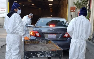 Three workers assist with a drive through drop off of HHW at the Marin Hazardous Waste facility.