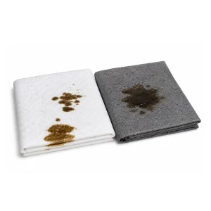 White and gray absorbent pads with visible oil stains, used to soak up oil and fuel spills from boats and marine equipment. Example materials accepted through the Oil & Absorbent Pad Exchange Program (OAEP).